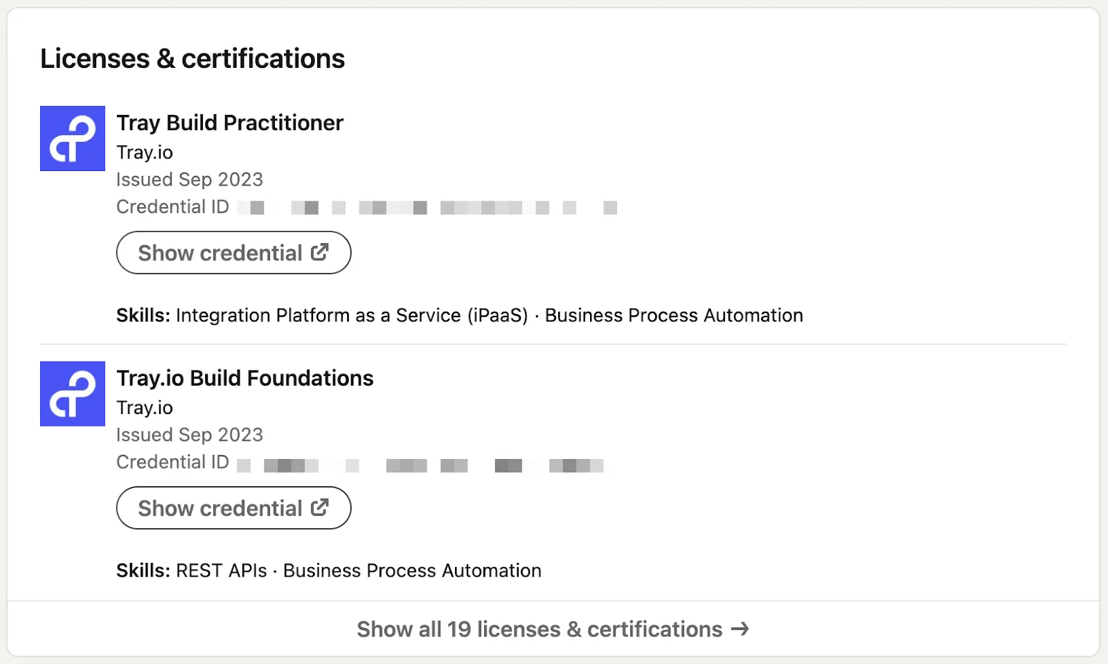 LinkedIn Licenses & certifications section displaying Tray Build Practitioner and Tray.io Build Foundations credentials issued by Tray.io.
