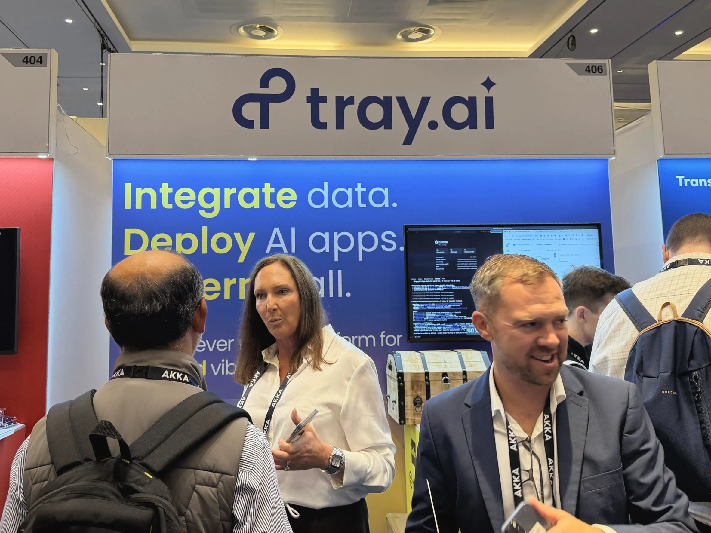 Attendees at the Tray.ai booth at Gartner Application Innovation Summit EMEA, in front of the "Integrate data. Deploy AI apps." signage